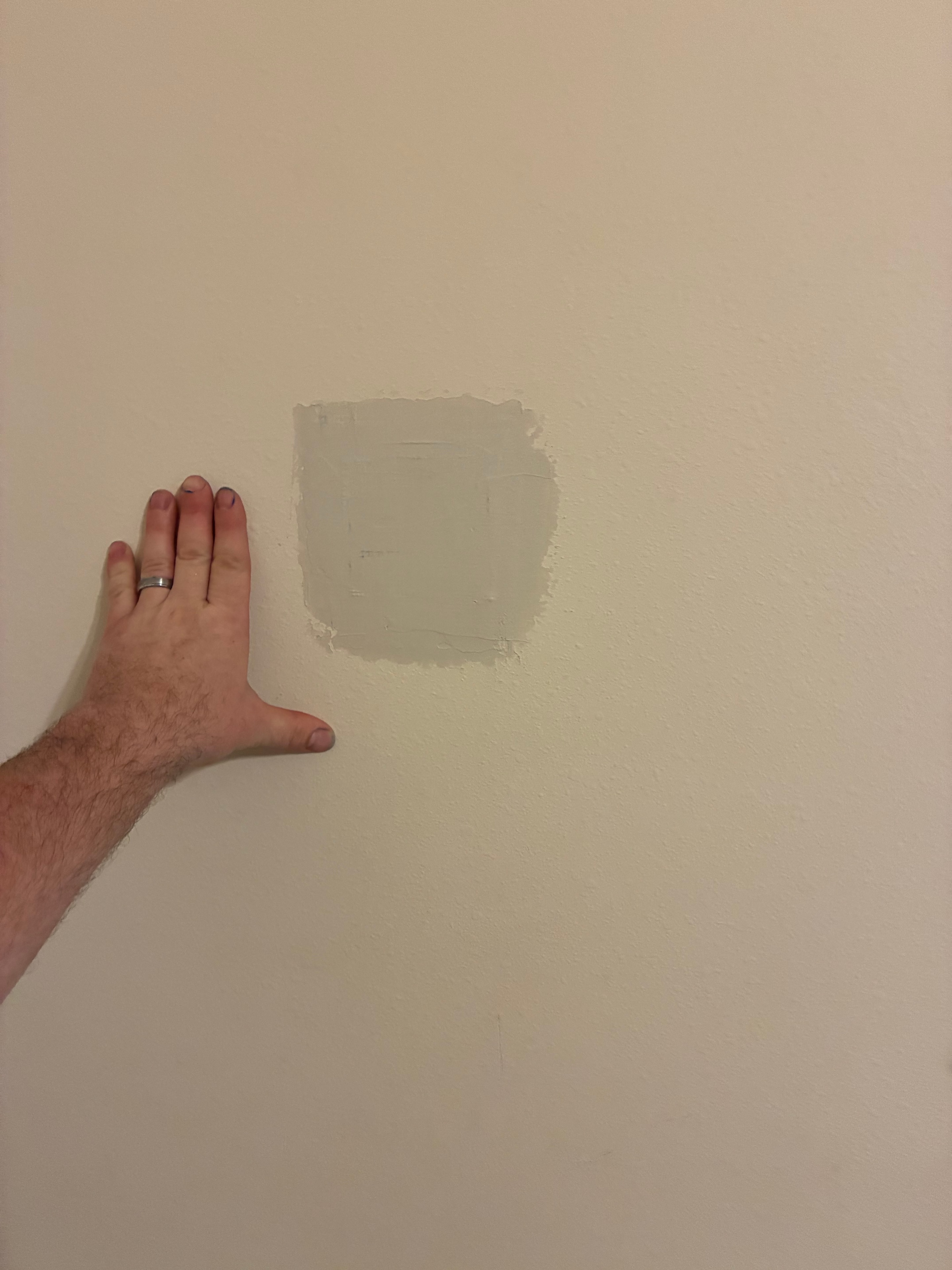 Drywall patch with compound applied to wall