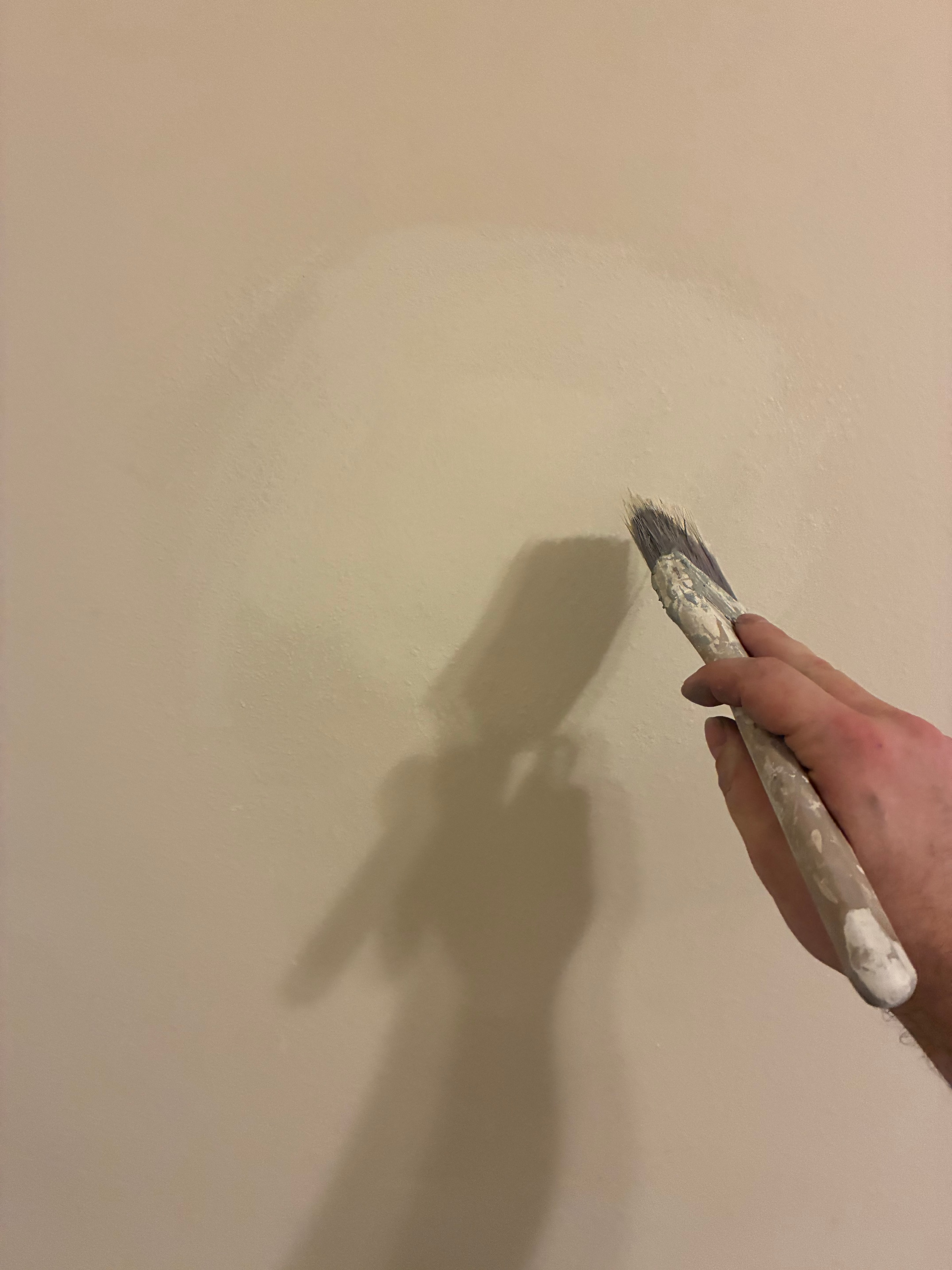 Brush touch-up on repaired drywall area